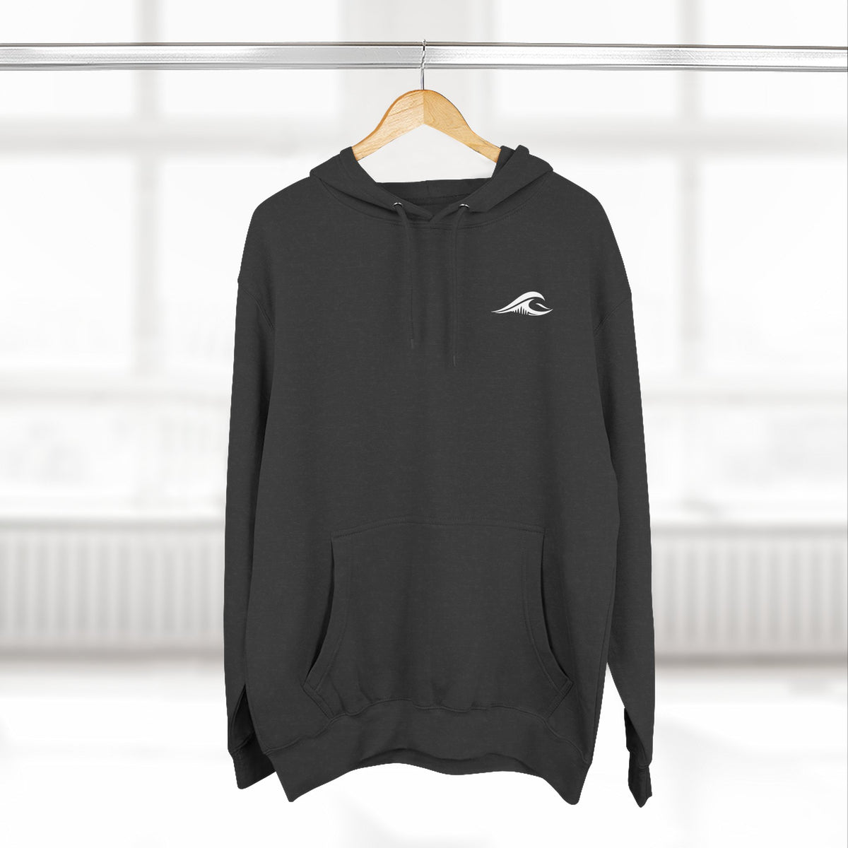 FLOWAV Coastal Graphic Hoodie in charcoal heather hanging on a wooden hanger showing the front wave logo