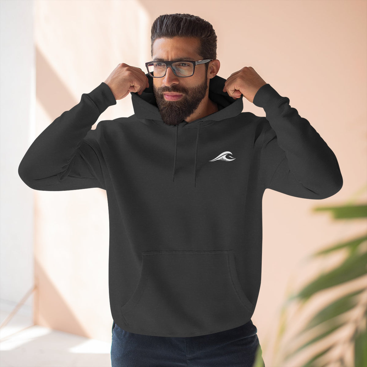 Man wearing the FLOWAV Coastal Graphic Hoodie in charcoal heather showing the front wave logo on the left chest.