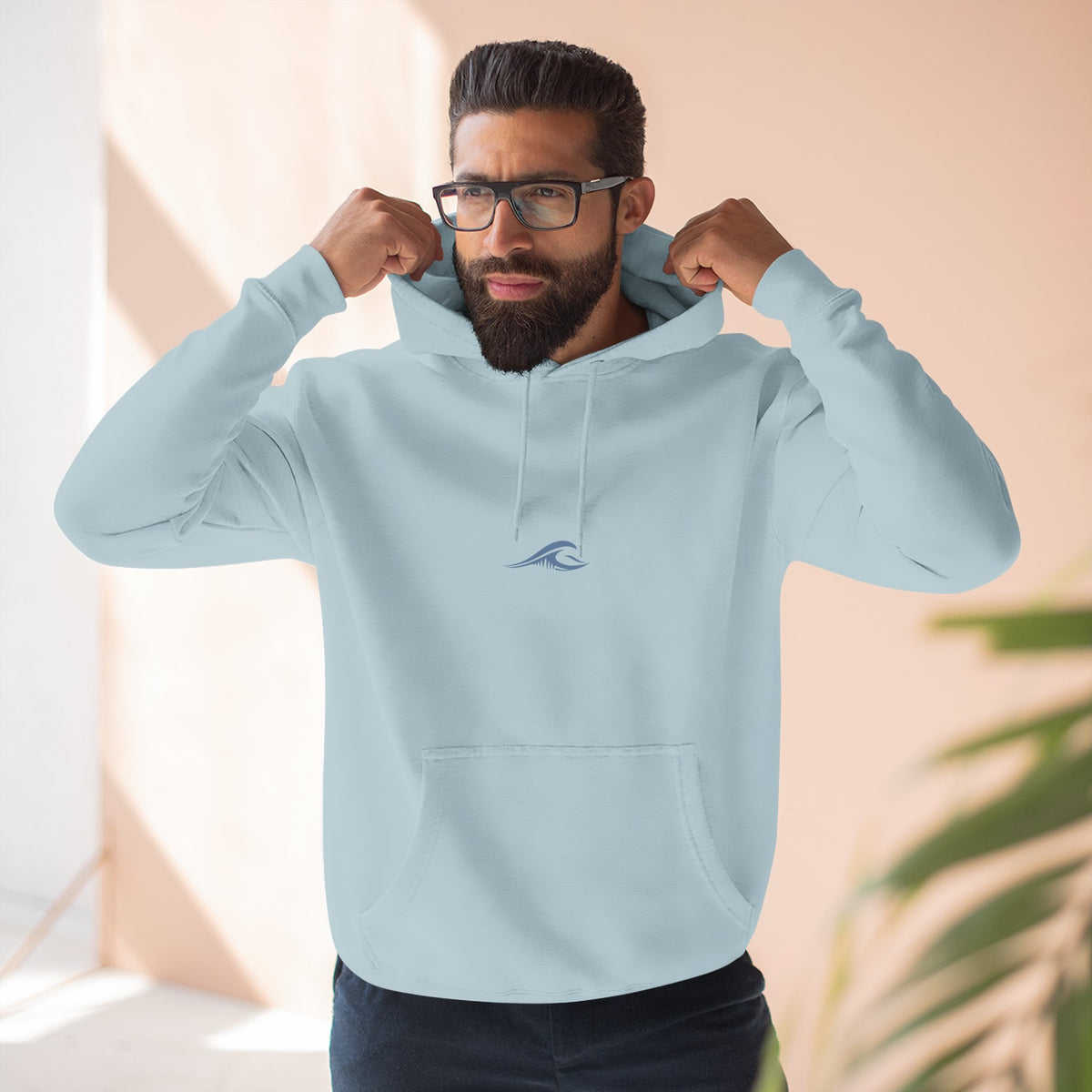 Man wearing the FLOWAV Signature Wave Hoodie in blue mist showing the front wave logo