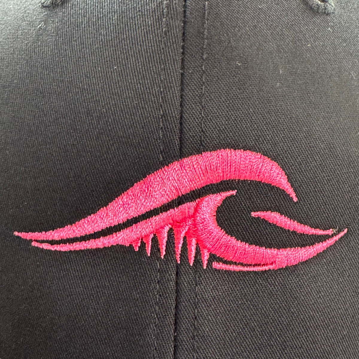 A closeup of the FLOWAV Pink Edition Richardson R112 Trucker hat pink embroidered wave graphic.