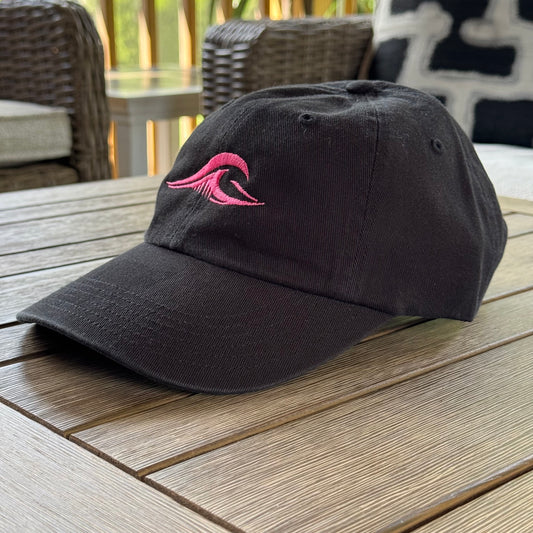 FLOWAV Pink Edition Richardson R55 classic dad hat showing an angled view of the pink wave resting on a wooden table.