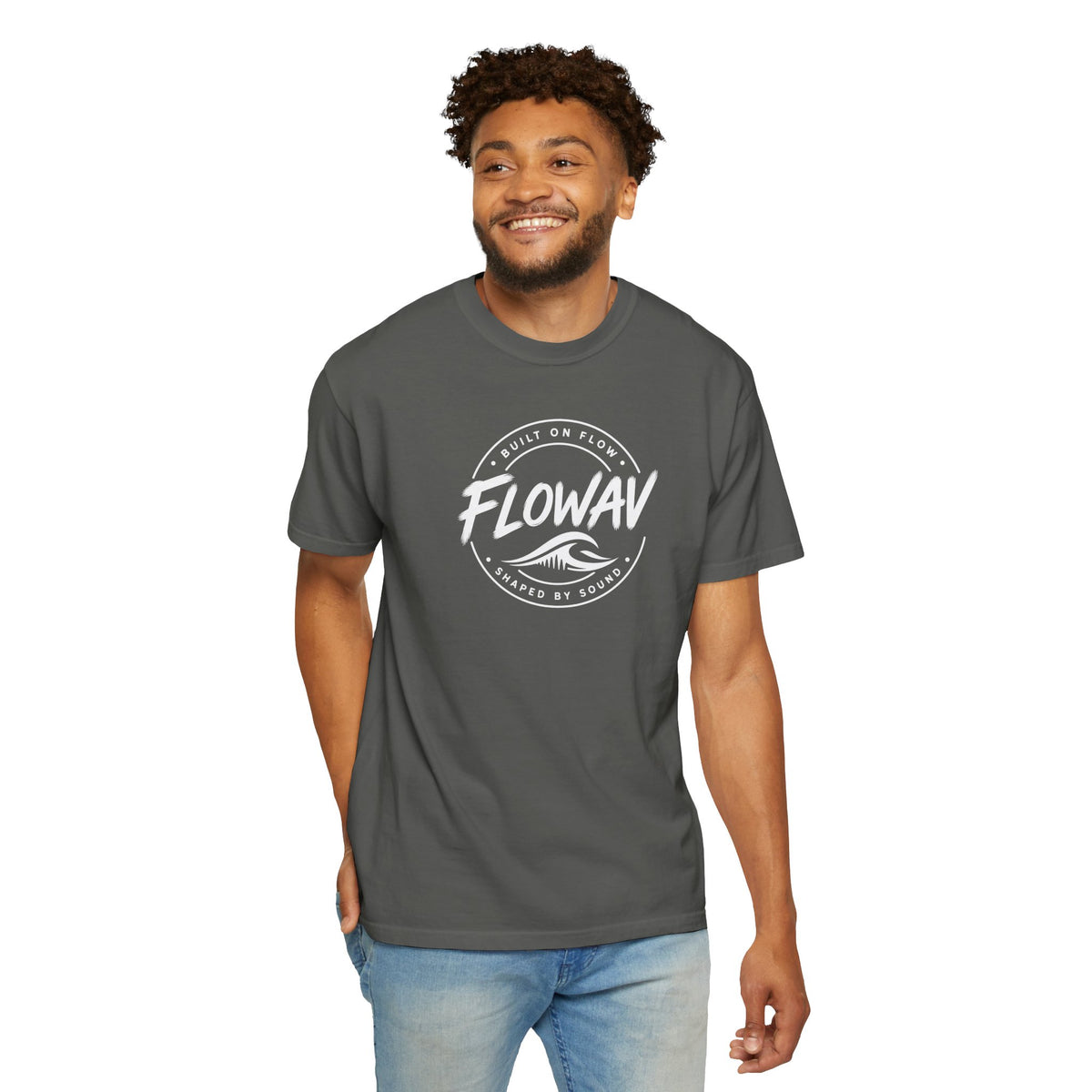 A man wearing the FLOWAV Coastal Badge Tee in pepper showing the front badge graphic.
