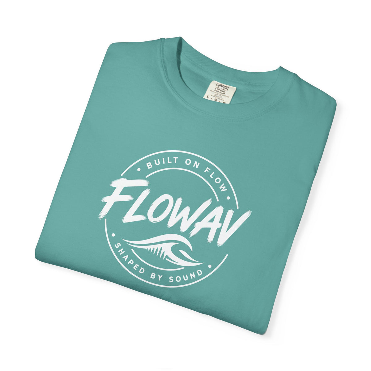 A folded FLOWAV Badge Tee in seafoam featuring built on flow shaped on sound slogan and a white wave logo.