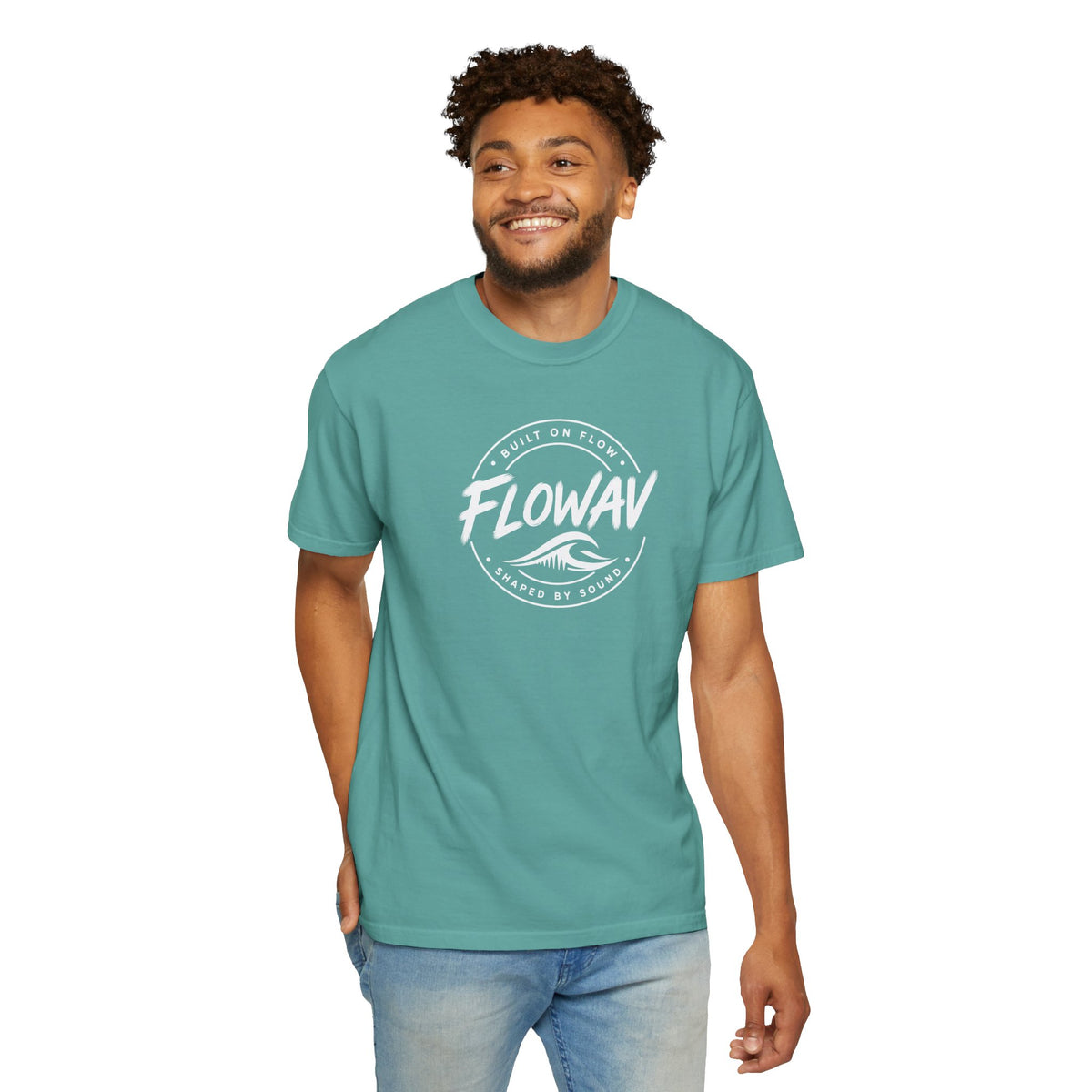 A man wearing the FLOWAV Coastal Badge Tee in seafoam showing the front badge graphic.