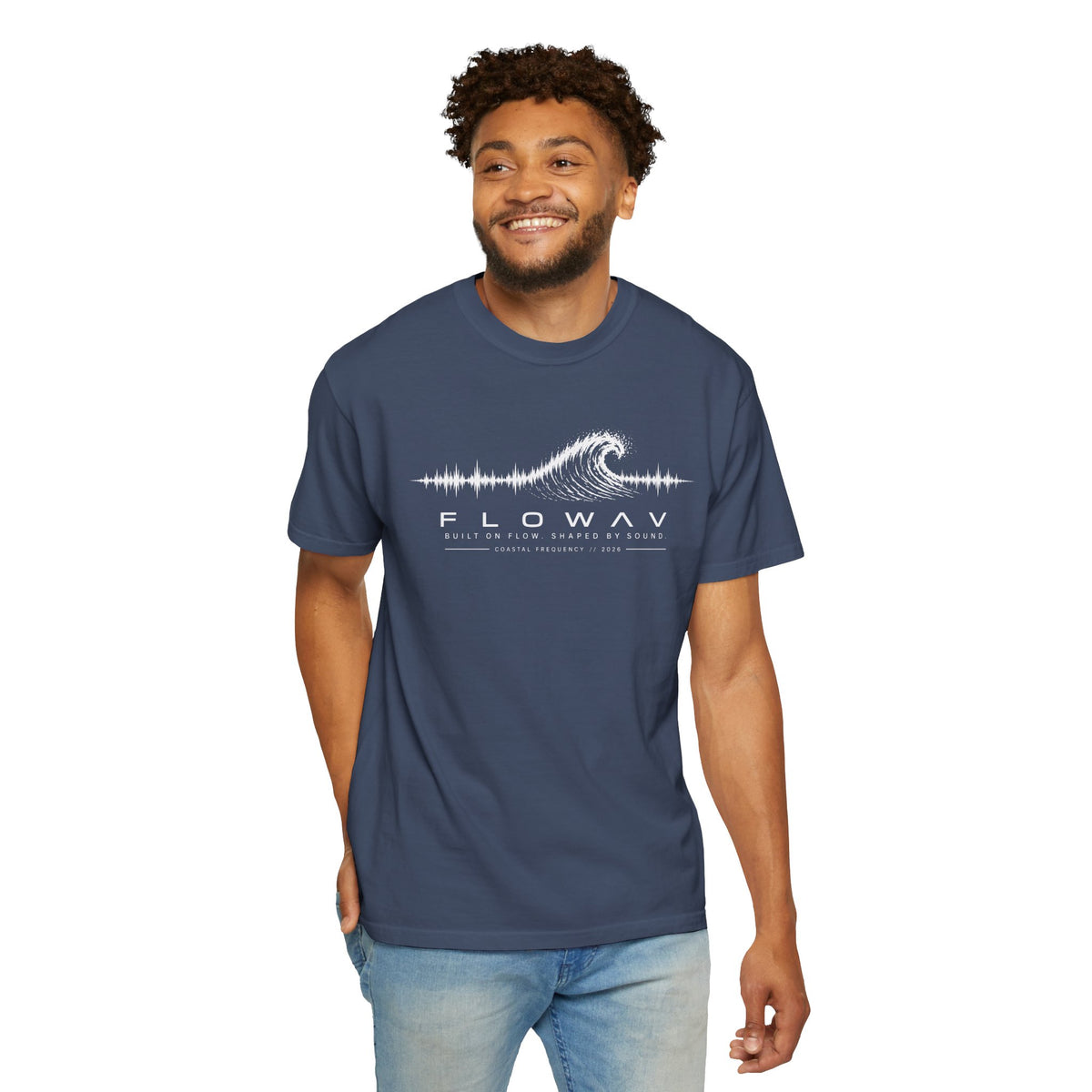 Man wearing FLOWAV Coastal Frequency Tee in Midnight featuring white wave and soundwave artwork.