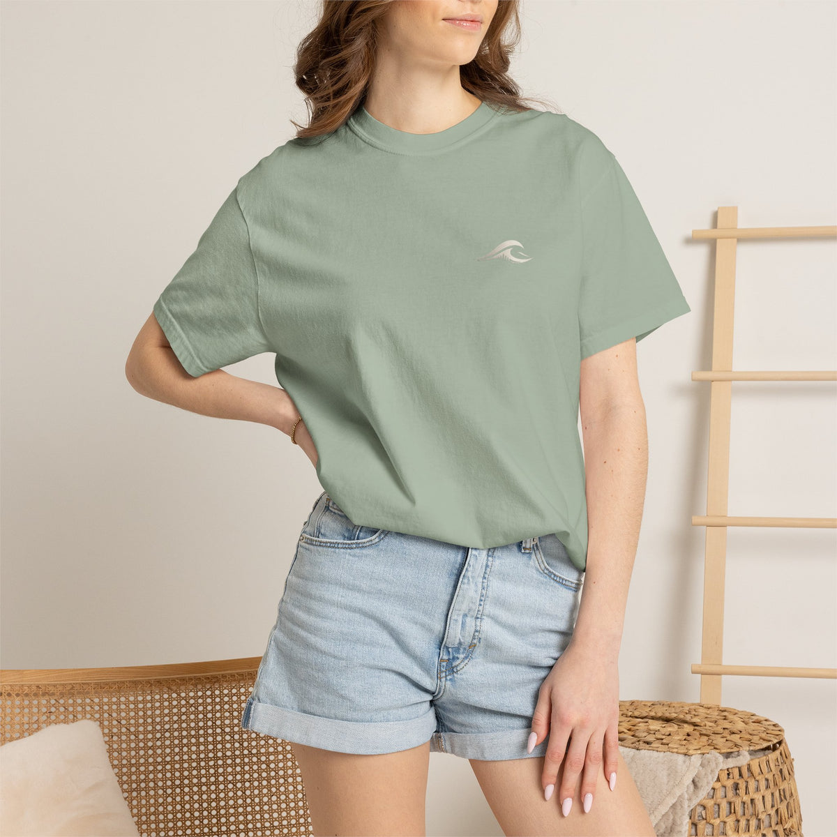 Woman wearing FLOWAV Coastal Graphic Tee in Bay - front view with wave chest logo