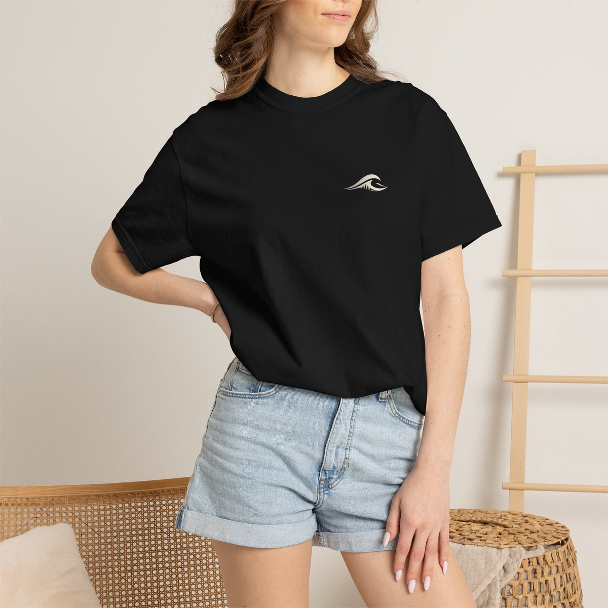 Woman wearing FLOWAV Coastal Graphic Tee in Black - front view with wave chest logo