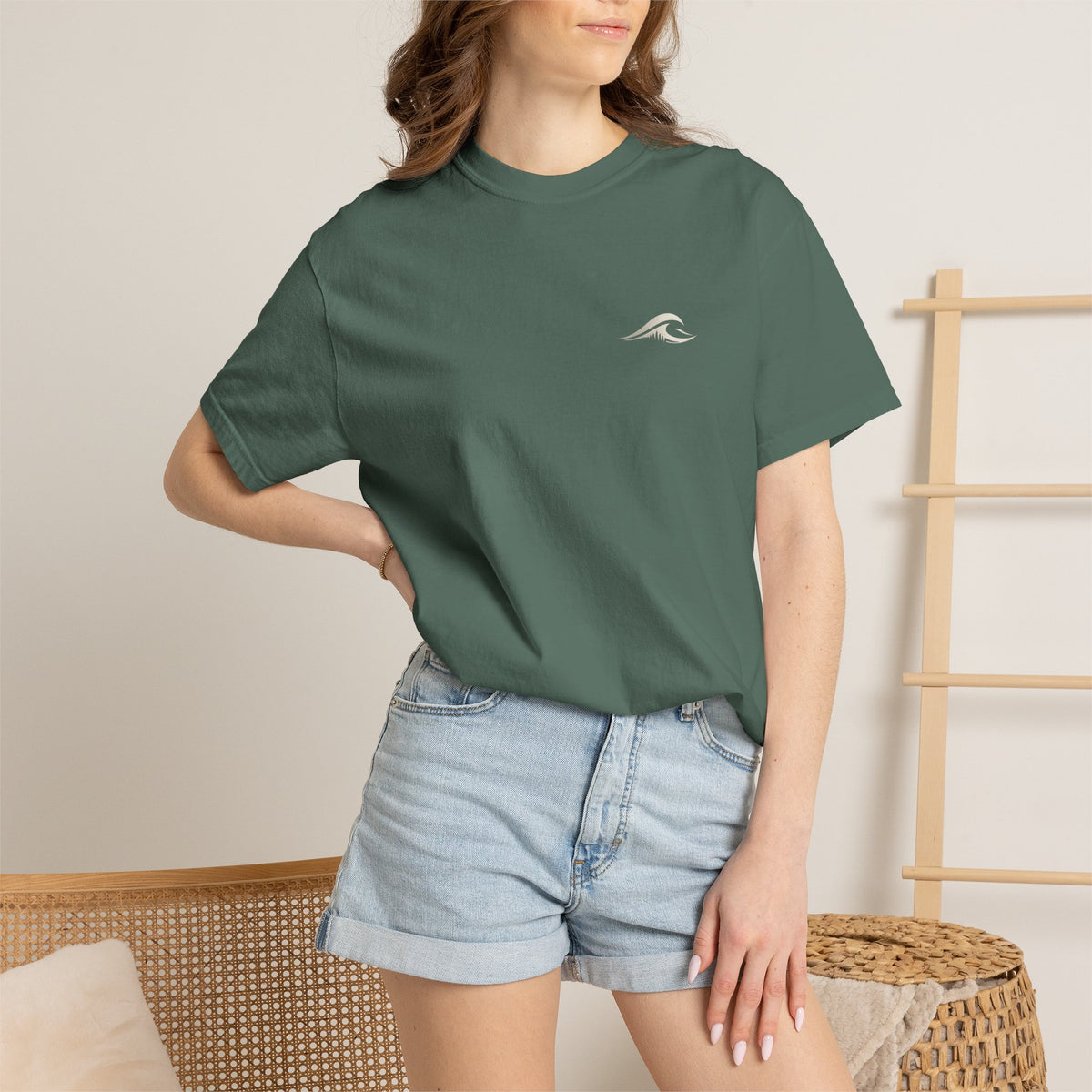 Woman wearing FLOWAV Coastal Graphic Tee in Blue Spruce - front view with wave chest logo