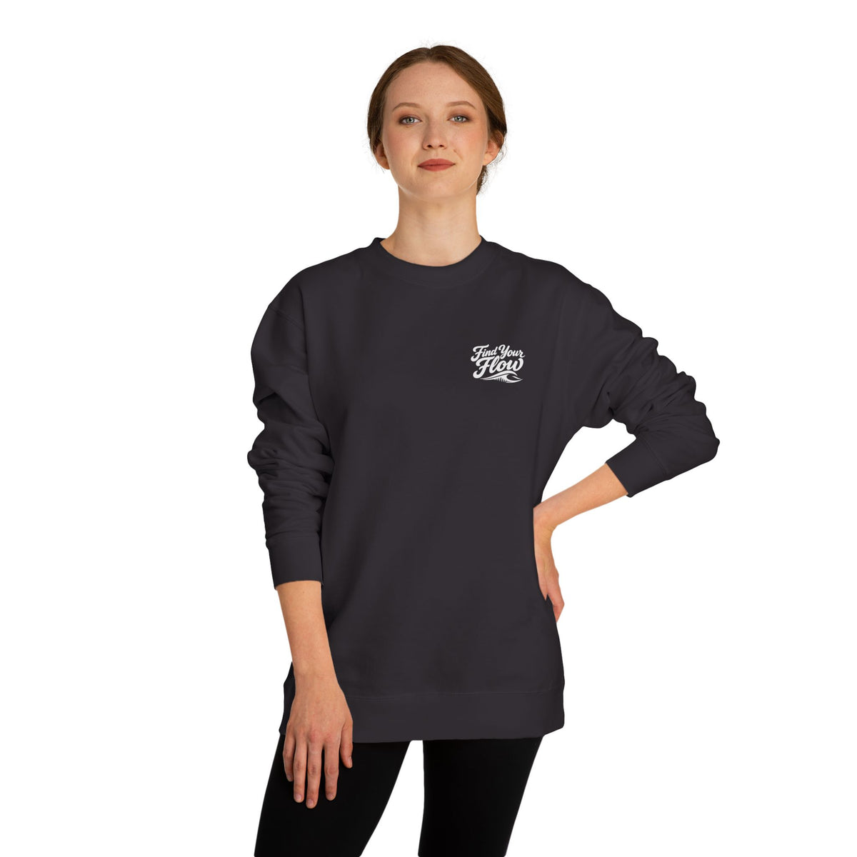 A woman wearing a FLOWAV Find Your Flow crewneck sweatshirt in black showing the front graphic and wave detail.