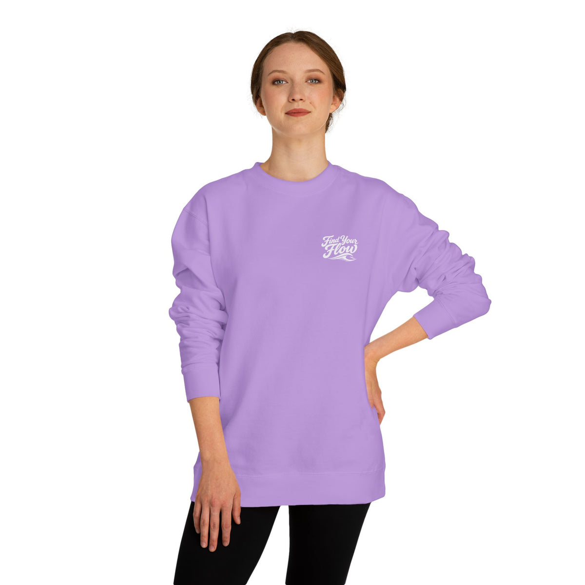 A woman wearing a FLOWAV Find Your Flow crewneck sweatshirt in lavender showing the front graphic and wave detail.