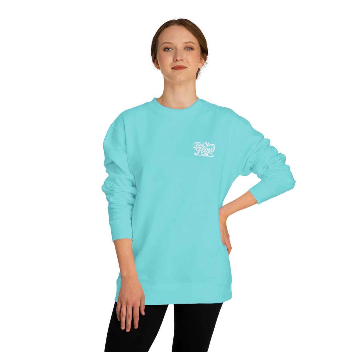 A woman wearing a FLOWAV Find Your Flow crewneck sweatshirt in mint showing the front graphic and wave detail.
