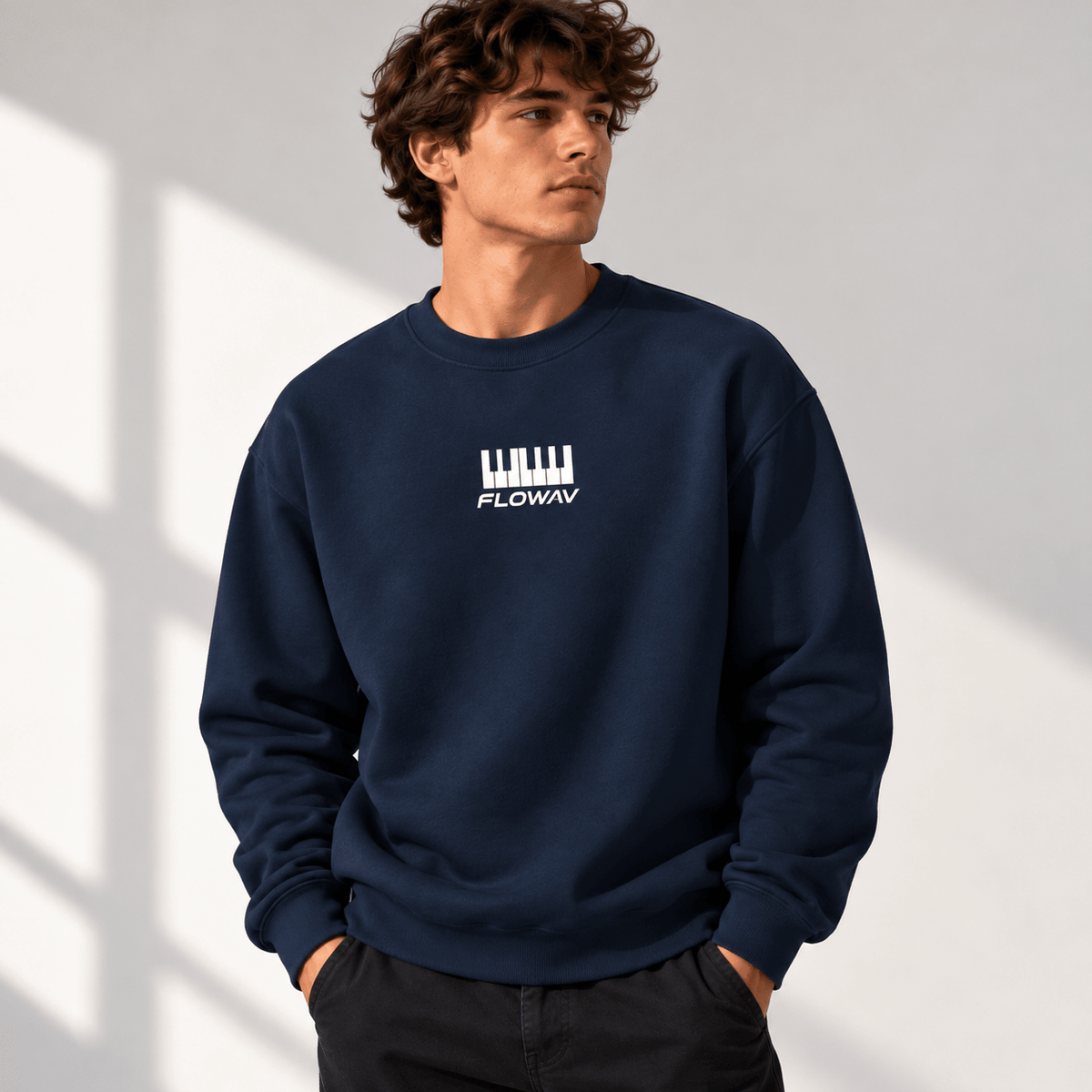 Man with long wavy hair wearing the FLOWAV Keys Crewneck Sweatshirt showing the front piano keys graphic