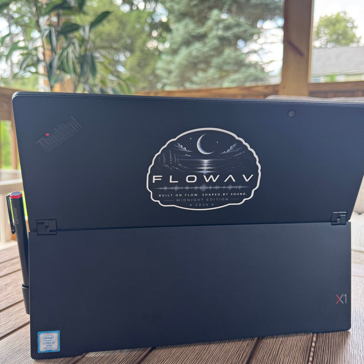 FLOWAV Midnight Edition Vinyl 4" sticker on the back of a laptop. Features a night scene with a creasant moon shining over the ocean.