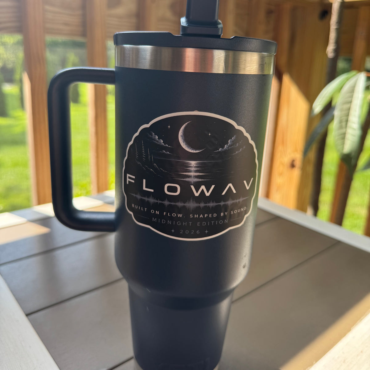 FLOWAV Midnight Edition Vinyl Sticker on a navy tumbler featuring an audio waveform and a nighttime scene of a moon over the ocean with trees and granite rocks.
