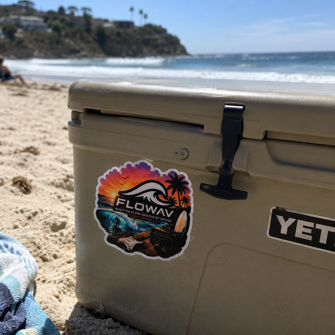 FLOWAV Sunset Vinyl Sticker applied to a beach cooler beside the ocean
