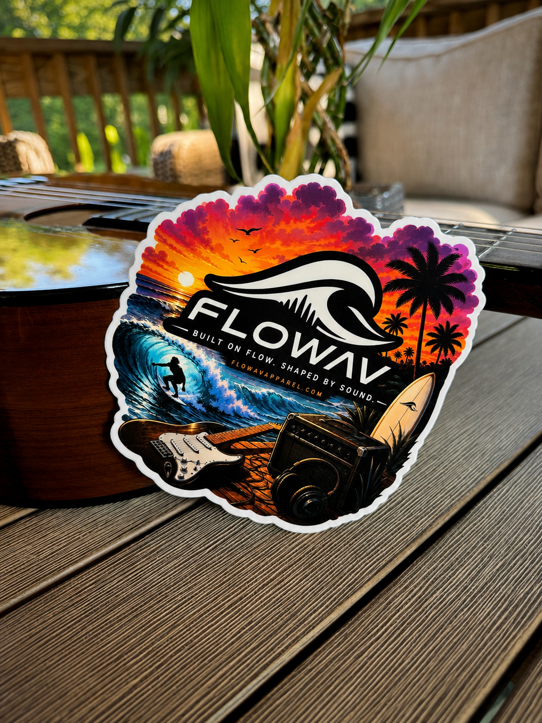FLOWAV Sunset Sticker displayed on an acoustic guitar in an outdoor setting