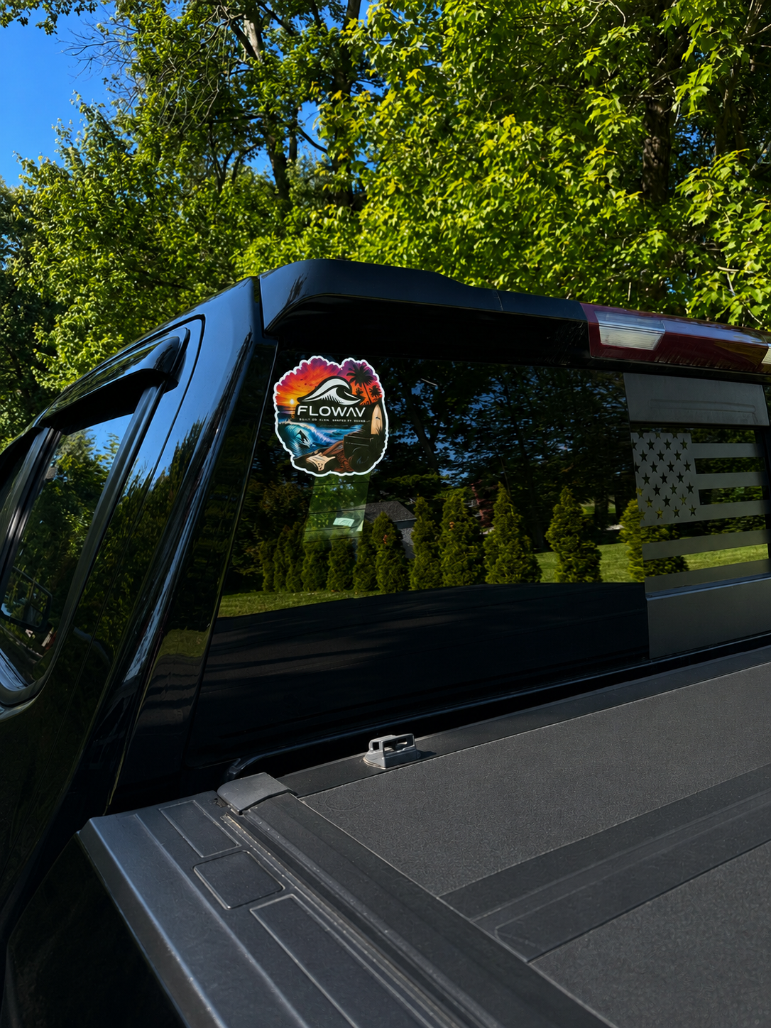 FLOWAV Sunset Sticker displayed on a pickup truck rear window