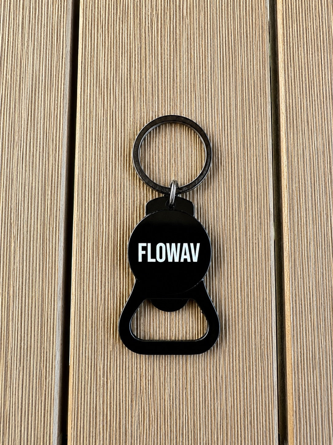 Black FLOWAV bottle opener keychain with FLOWAV branding