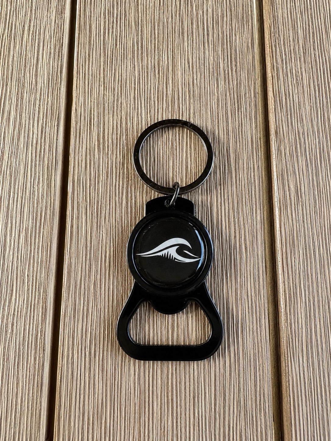 Black FLOWAV bottle opener keychain with wave logo